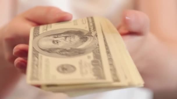 Money in hand, bills of 100 dollars. Selective focus. Demonstrate earnings, financial literacy. The concept of investment, business, money exchange or payout - Footage, Video