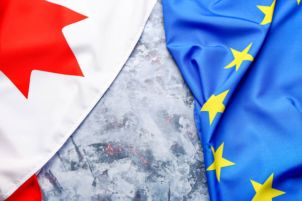 Flags of European Union and Canada on grey grunge background - Foto, Bild