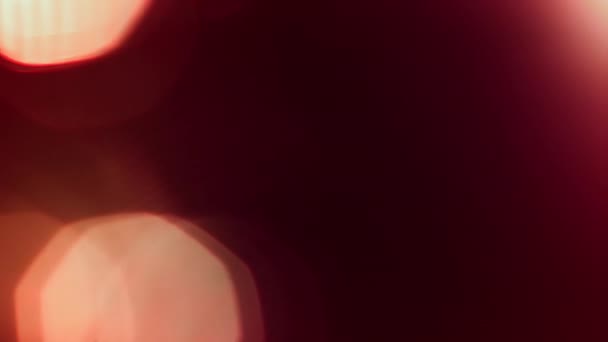 Abstraktes rot-orangefarbenes Bokeh-Schleifen-Hintergrundbild. Weich getönte lebendige defokussierte Dekor-Vorlage Kopierraum Backplate. Makro-Close-up-Glüheffekt Produkt Schaufenster Hintergrund Animation. - Filmmaterial, Video
