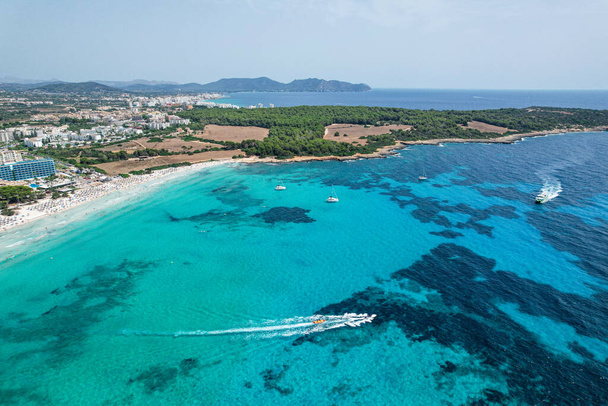 Vue aérienne d'une promenade en bateau Banane sur la plage de Sa Coma à Majorque, en Espagne, un jour d'été - Photo, image