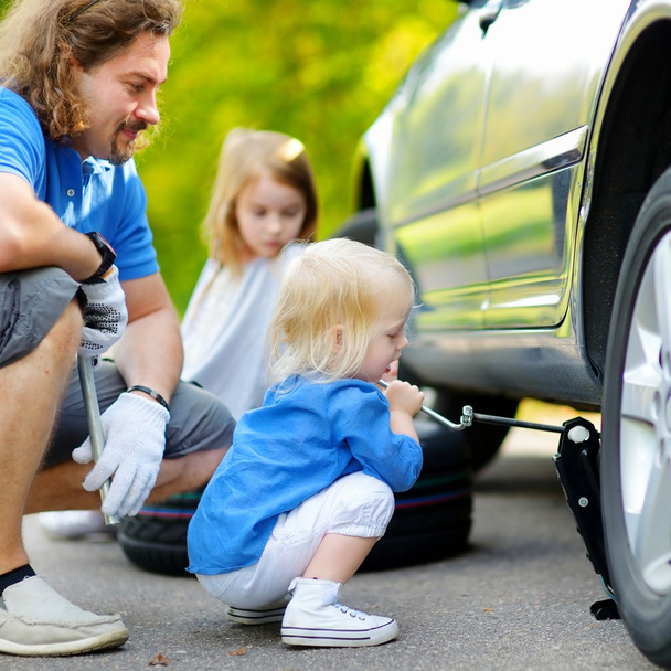 Little girl helping father with car - Photo, image