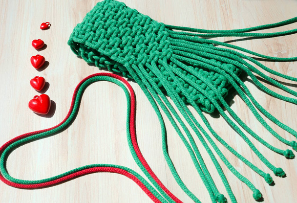 Small green macrame bag. ECO bag made of Turkish yarn for a mobile phone. - Photo, Image