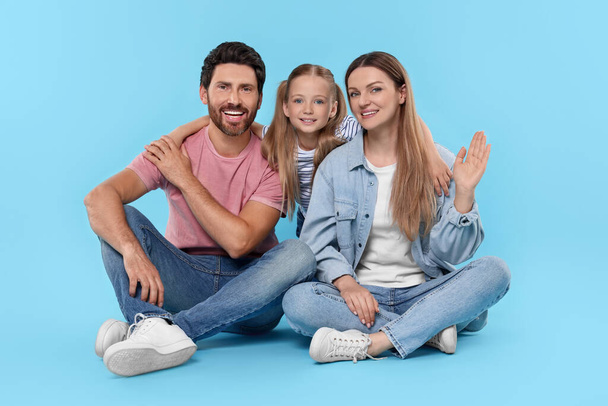 Happy family together on light blue background - Valokuva, kuva