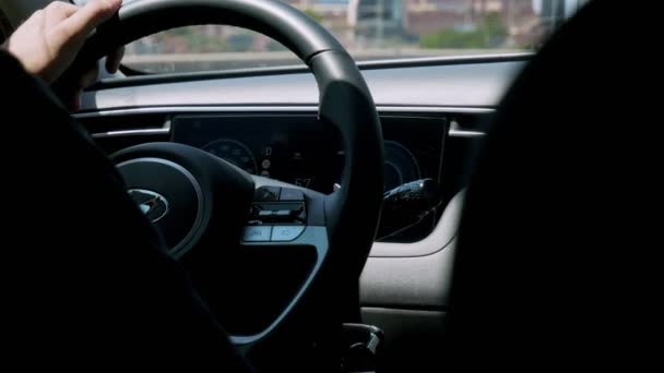 Cagliari, Sardinia, Italy: JUL 21 2023: man driving car in city in summer with Hyundai logo on steering wheel - Footage, Video