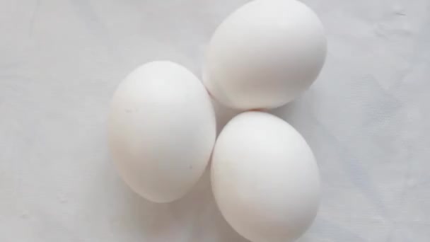 chicken eggs on a white table cloth, top view - Footage, Video
