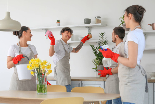 Young janitors cleaning in kitchen - Foto, Imagen