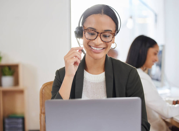 Woman, microphone and laptop in call center for customer service, support and telemarketing. Face of a african female agent or consultant talk on headset for sales, crm or help desk for online advice. - Photo, Image