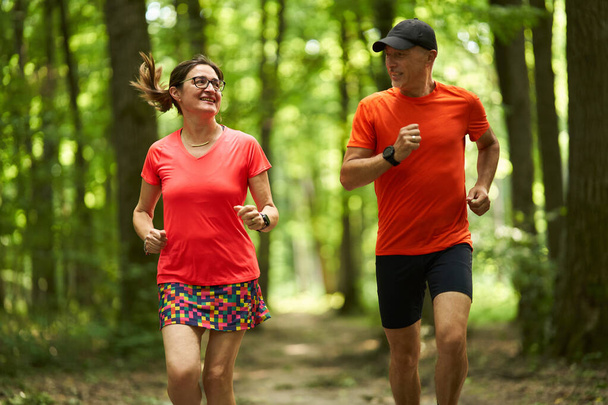 Runners couple endurance running on forest trails               - Φωτογραφία, εικόνα