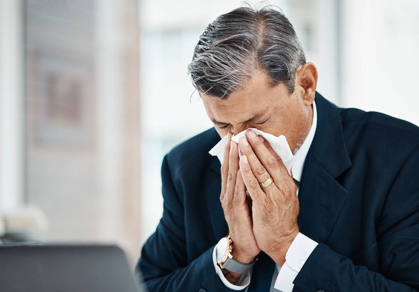 Sick, mature man and blowing nose in office with allergy, covid or virus in business company. Tissue paper, professional or manager with allergies for health problem, cold fever or bacteria in winter. - Photo, Image