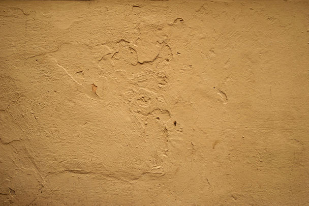 Texture of old wall covered with yellow stucco - Foto, Imagen