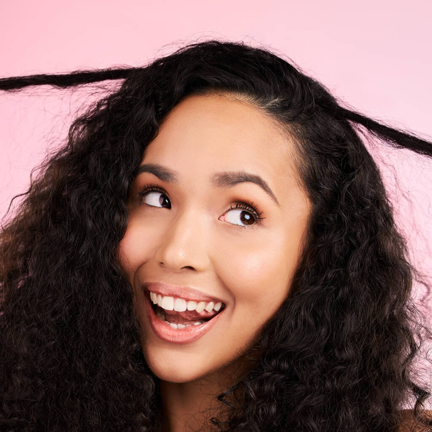 Beauty, curly hair and smile with face of woman in studio for cosmetics, textures and salon treatment. Shampoo, skincare and hairstyle with model on pink background for self care, facial and glow. - Фото, зображення