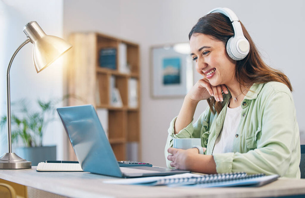Laptop, study and headphones with woman in home office for elearning, education and blog. Digital, online class and college with female student and research for streaming, virtual and subscription. - Photo, Image