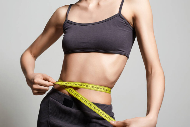 Young woman measuring her thin waist. Beautiful body Thin Girl - Fotó, kép