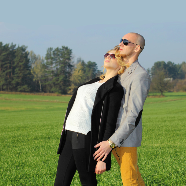 Young beautiful couple in  field - Photo, image