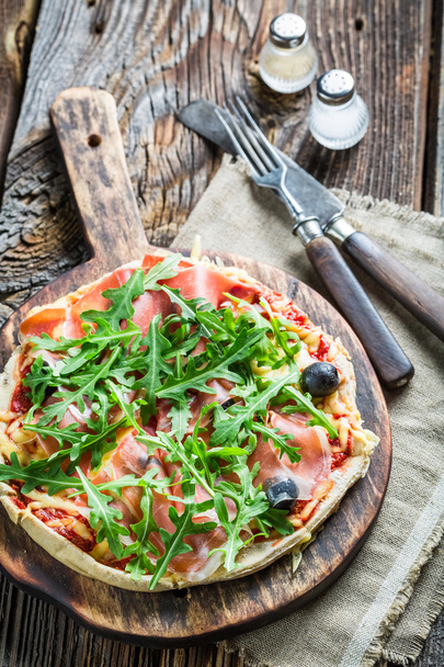 Freshly baked pizza served on old wooden table - Photo, Image