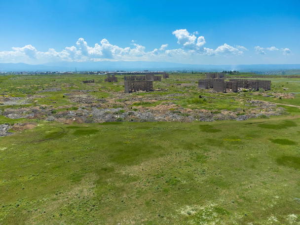 Drone view on a sunny summer day of the remains of buildings destroyed by the earthquake on December 7, 1988 in the city of Gyumri in Armenia - Photo, Image