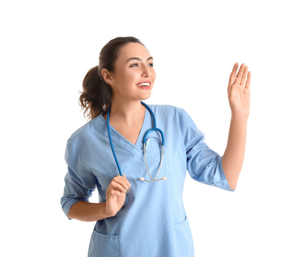 Female medical assistant with stethoscope on white background - Foto, Imagen