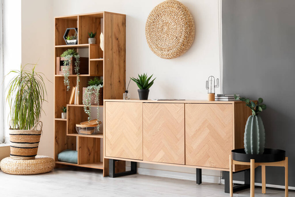 Wooden cabinet and shelving unit in interior of stylish room - Fotó, kép
