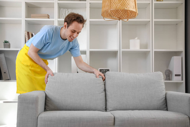 Young man cleaning his apartment - Foto, imagen