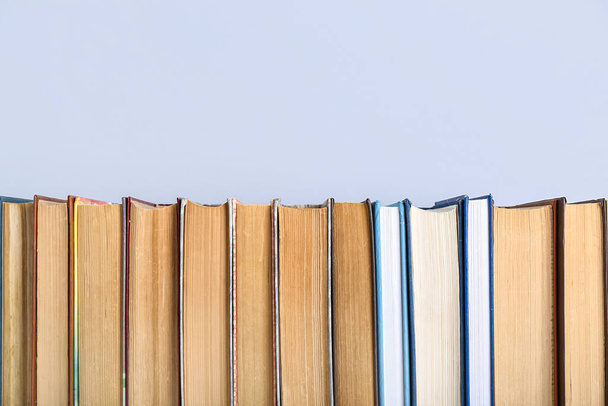 Row of books on grey background - Foto, Imagen