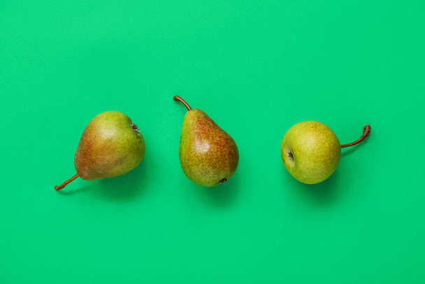 Ripe pears on green background - Photo, Image