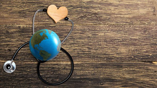 Earth with a stethoscope and heart shape. World heart day concept - Foto, Bild