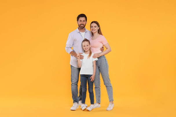 Portrait of happy family on orange background - Foto, afbeelding