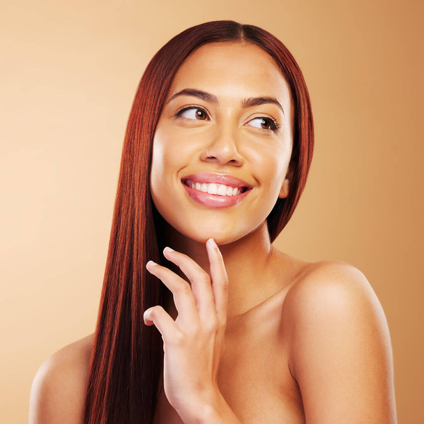 Hair care, beauty and portrait of happy woman with glow, hand on skin and luxury salon treatment on brown background. Smile, haircut and haircare, face of model with cosmetics and makeup in studio - Foto, Bild