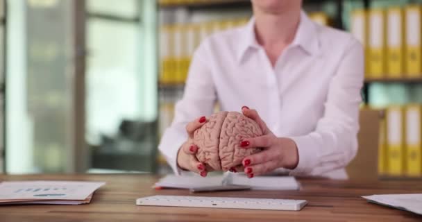 Female manager puts anatomy of brain on computer keyboard. Artificial intelligence and the global Internet network - Footage, Video