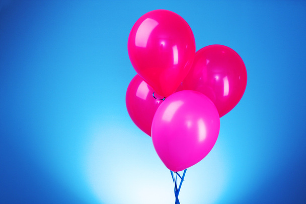 Pink flying balloons on a blue background - Fotoğraf, Görsel