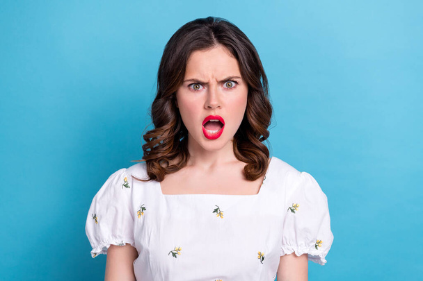 Photo portrait of lovely young lady scream shout offended frowning wear trendy white garment isolated on blue color background. - Foto, afbeelding