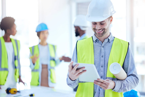 Construction worker, tablet and man with blueprint of engineer, builder or contractor. Industrial, handyman app and male person with digital info and smile from engineering and architecture project. - Photo, Image