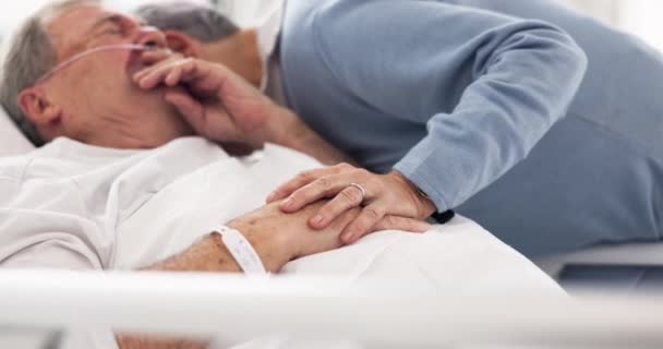 Hospital, sad or elderly couple, sick patient and hug for empathy, marriage bond and support for senior person. Healthcare crisis, whisper and man cough from medical problem, cancer or disease in bed. - Filmmaterial, Video