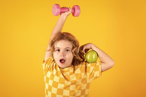Child boy working out with dumbbells. Kids sport and active healthy life. Sport and kids training - Photo, Image