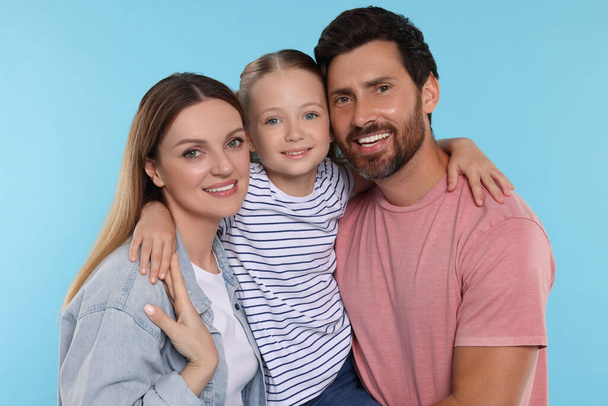 Happy family together on light blue background - Фото, зображення