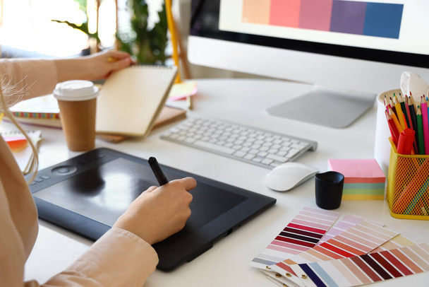 Diseñadora gráfica femenina trabajando con tablet en mesa en oficina, primer plano - Foto, Imagen