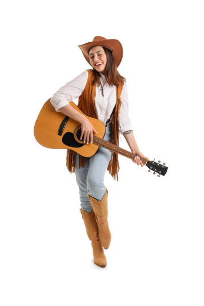 Beautiful cowgirl playing guitar on white background - Fotó, kép