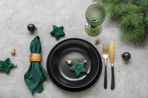 Beautiful table setting for Christmas celebration on grey background - Valokuva, kuva