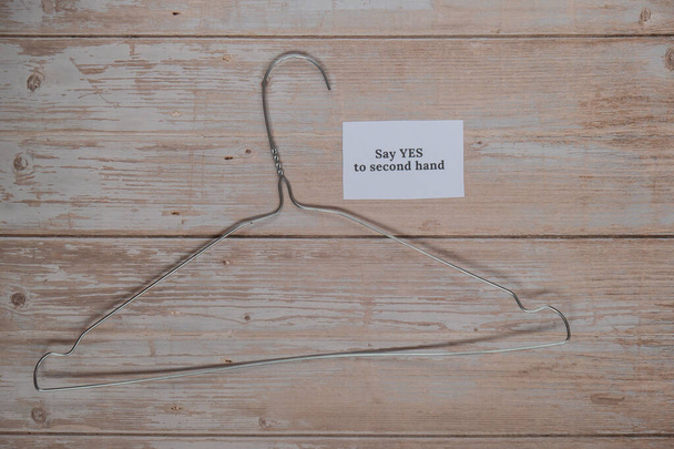 SAY YES TO SECOND HAND text with clothes rack. Second hand sustainable shopping. Capsule minimal wardrobe. Sustainable fashion overconsumption, conscious buying consumption, slow fashion idea concept - Photo, Image