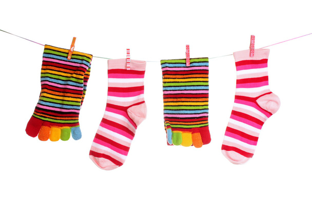 Socks hanging isolated on white - 写真・画像
