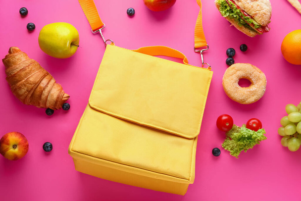 Lunch box bag with different tasty food on pink background - Photo, Image