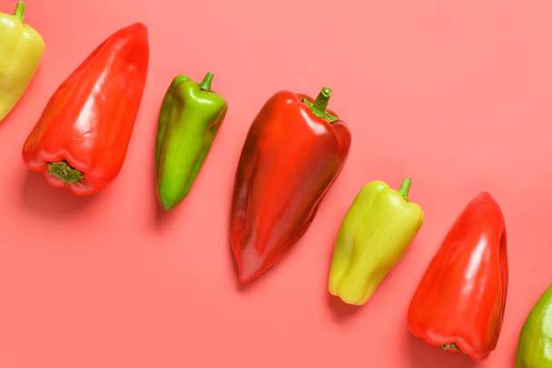 Different fresh bell peppers on red background - Φωτογραφία, εικόνα