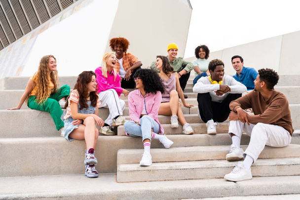 Happy playful multiethnic group of young friends bonding outdoors - Multiracial millennials students meeting in the city, concepts of youth, people lifestyle, diversity, teenage and urban life - Φωτογραφία, εικόνα