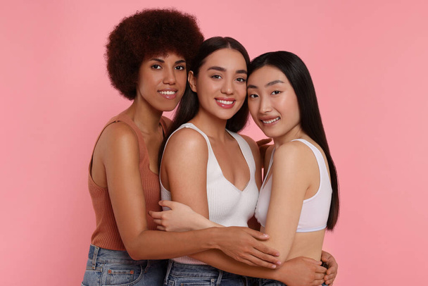 Portrait of beautiful young women on pink background - Photo, Image