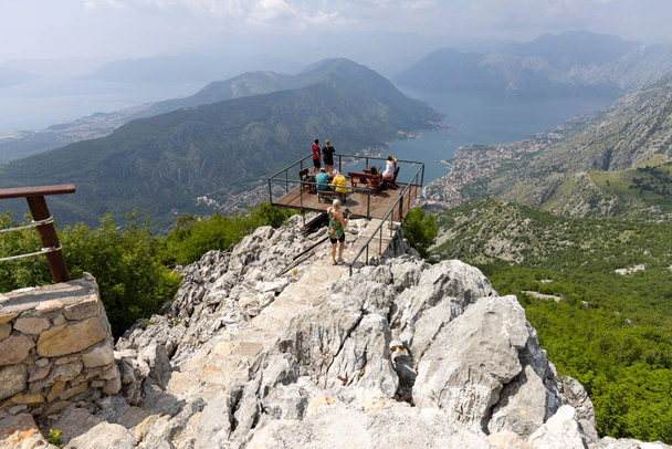 Kotor, Montenegro - June 26, 2023: People on observation deck on the top of the mountain with beautiful view of Kotor of the Adriatic Sea. - Photo, Image