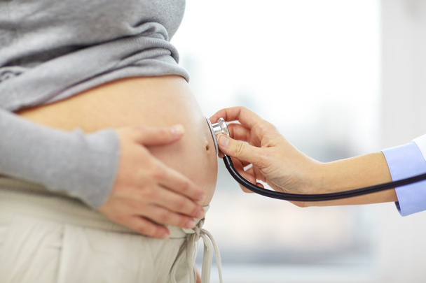 pregnant woman belly and doctor - Φωτογραφία, εικόνα