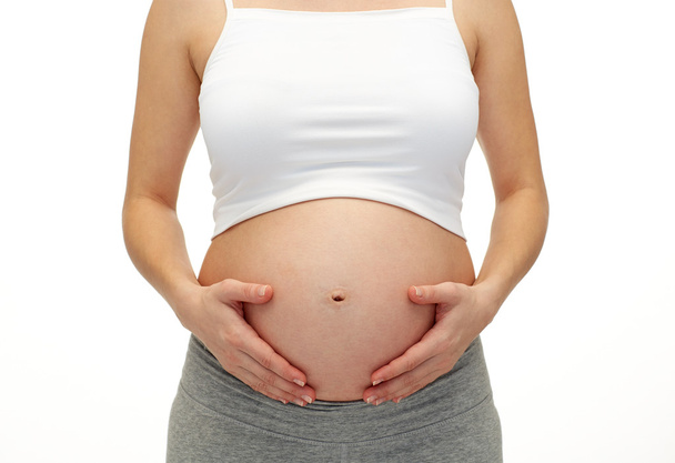 Pregnant woman touching her  tummy - Foto, Imagem