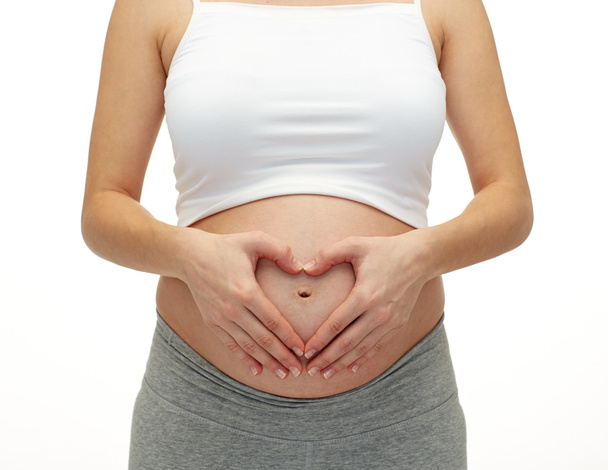 Pregnant woman touching her  tummy - Fotó, kép