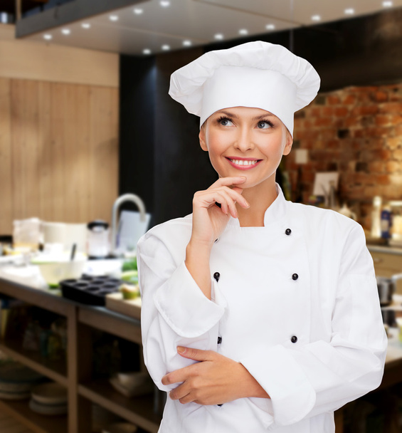 smiling female chef dreaming - Foto, Bild