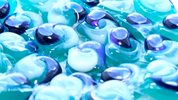 Powder and liquid blue washing machine detergent. macro Rotation. Vertical video. - Footage, Video